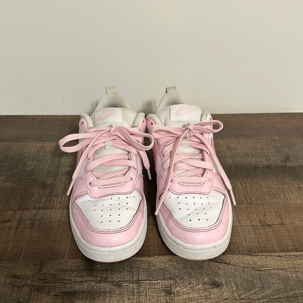 Girls pink and white low top Nike sneakers. Size 4.5y